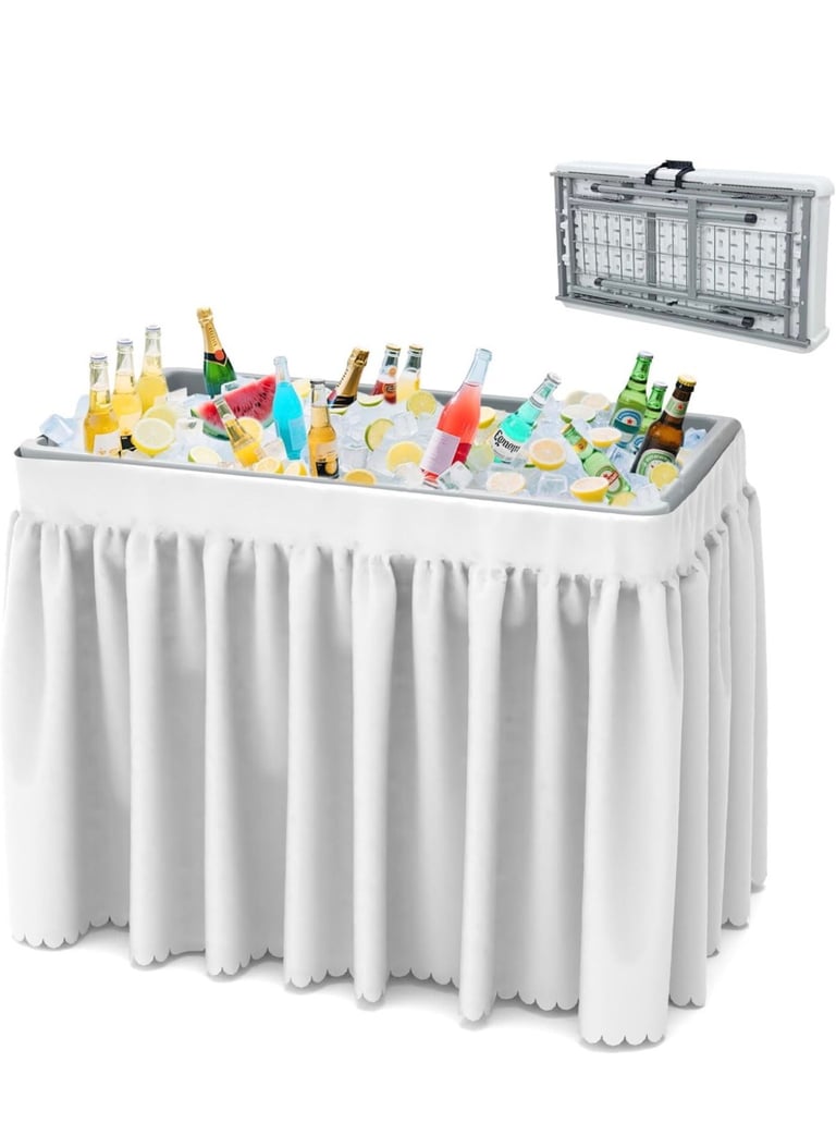 Portable beverage cooler bar table with white skirting, filled with drinks and ice, alongside a collapsible carrying case