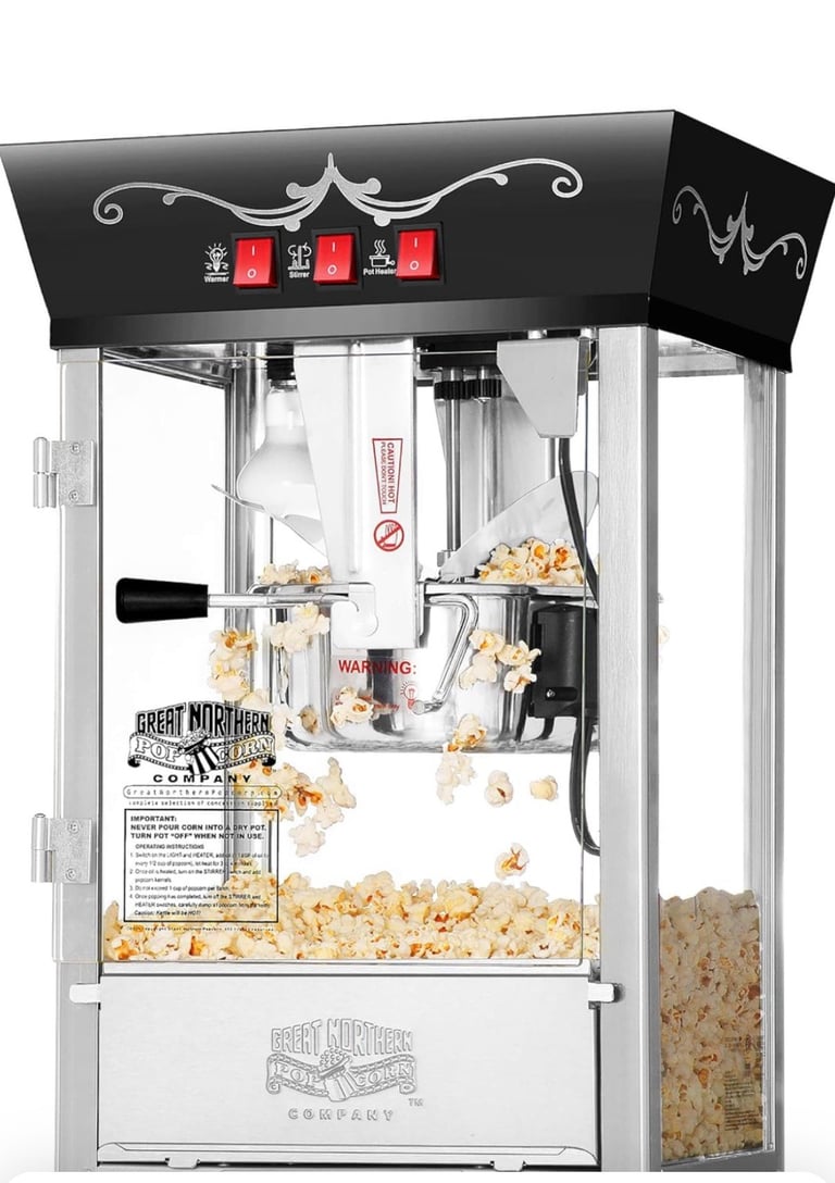 Professional vintage-style popcorn machine with black and silver design, glass sides, red signage, and popcorn dispensing into collection bin